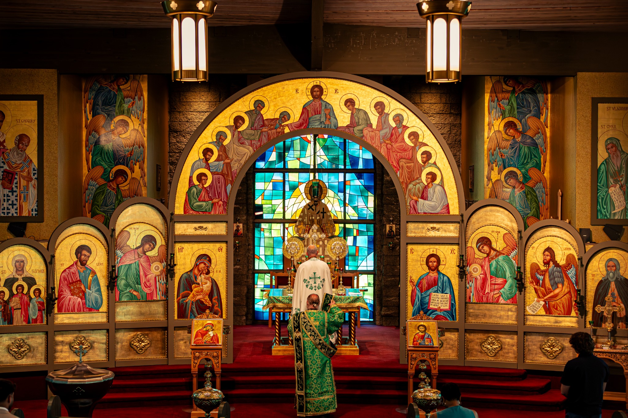 Divine services inside St. Luke Orthodox Church, with clergy before the iconostasis