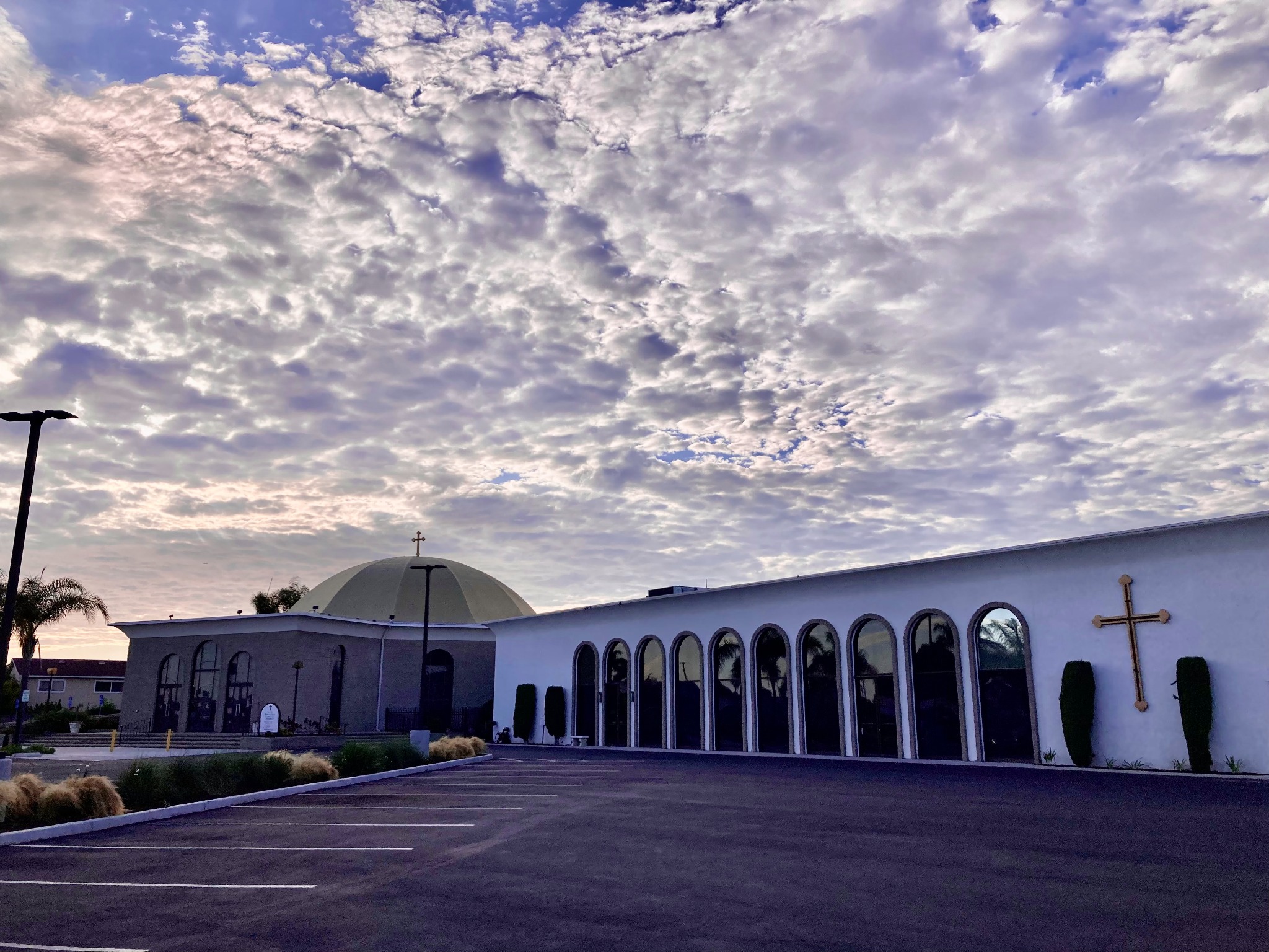 St. Luke Orthodox Church beneath a cloud-filled evening sky